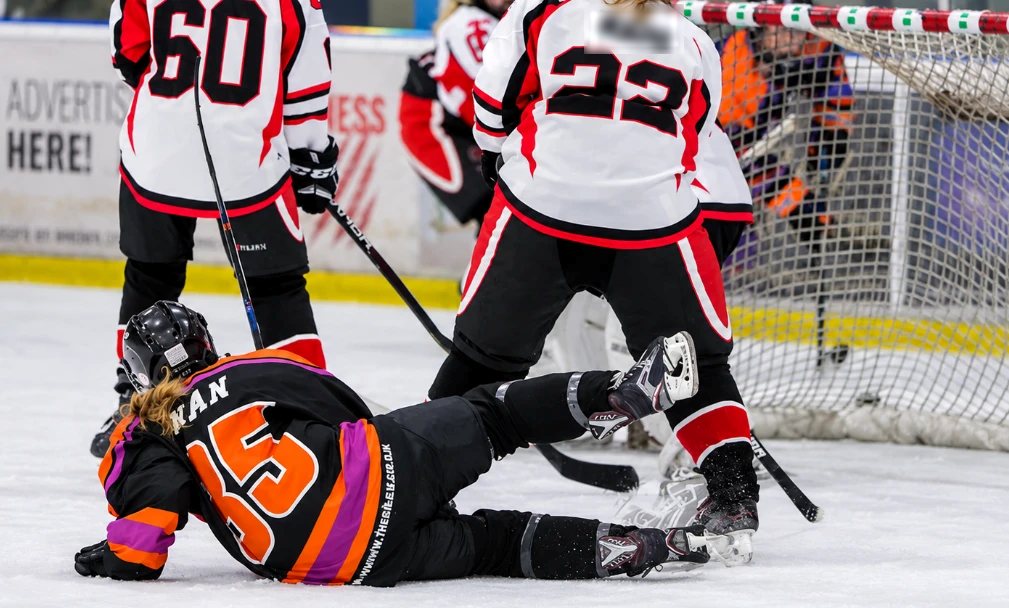Sabah, number 85, down on the ice in front of the goal during a match